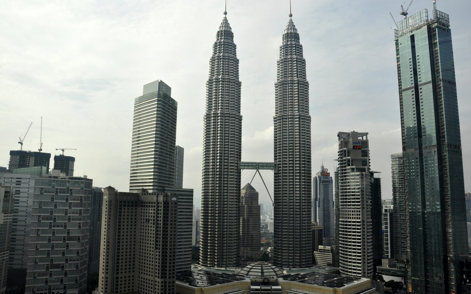 The Petronas Twin Towers rising above the Kuala Lumpur skyline at dusk