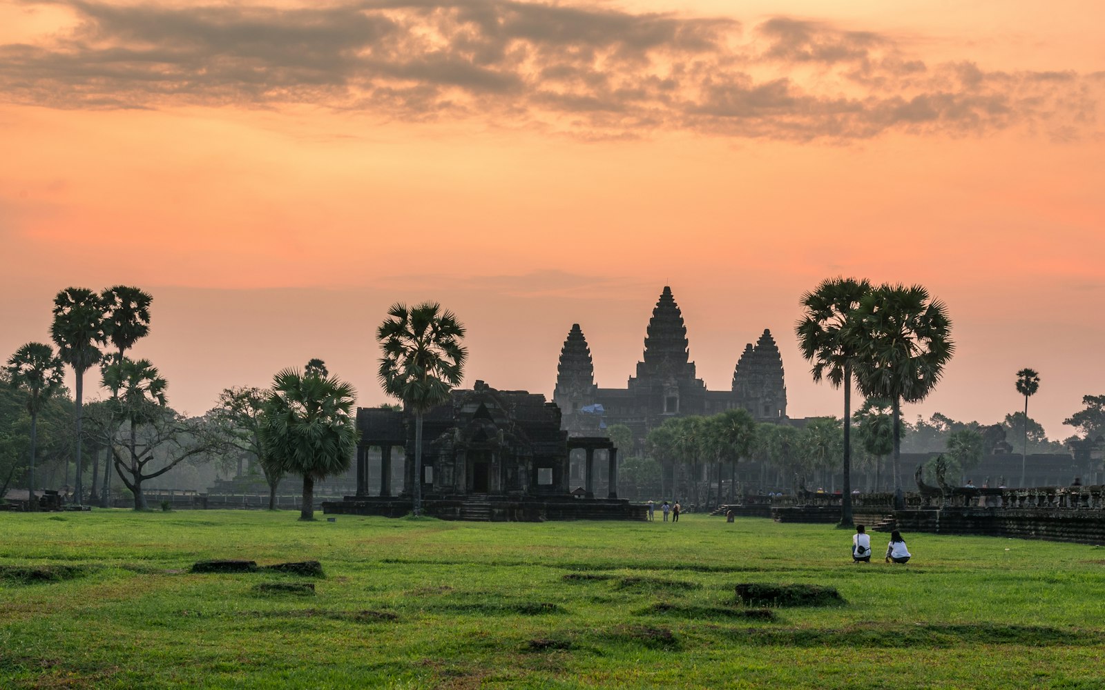 Sunrise over the towers of Angkor Wat reflected in a pond near Siem Reap, Cambodia